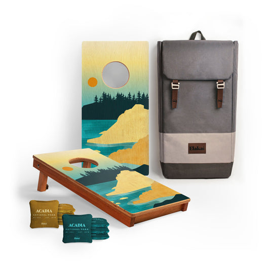Cornhole board with Adadia National Park design, cornhole bags, and a backpack