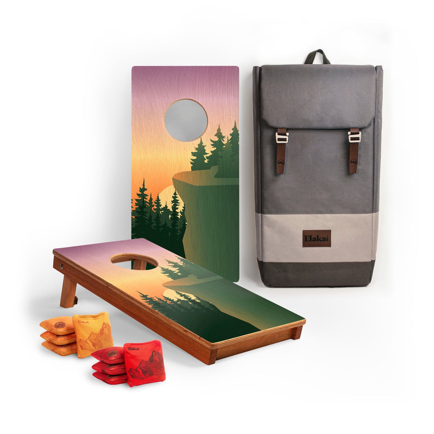 Cornhole boards with a cliff design, cornhole bags, and a backpack