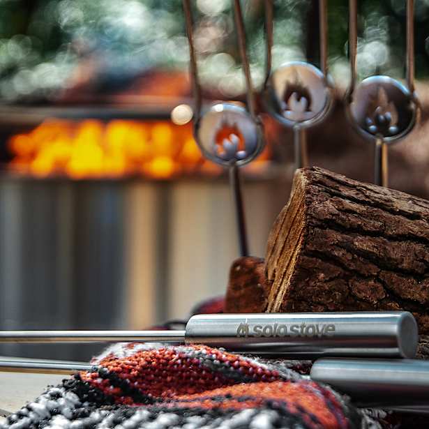Sole Stove with logs and fire in the background
