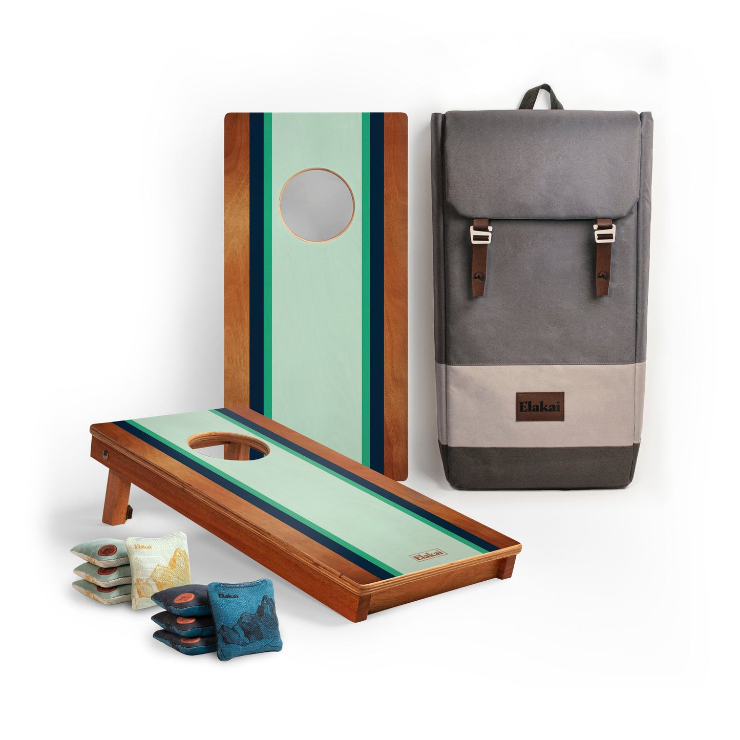 Cornhole boards with mint green striped design, cornhole bags, and a gray backpack 