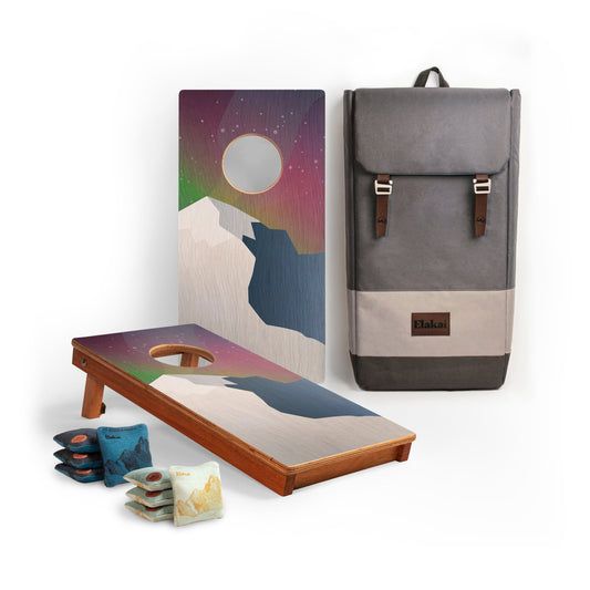 Cornhole boards with aurora sky and mountain design, cornhole bags, and a backpack