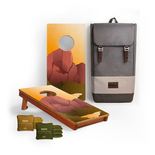 Cornhole boards with mountain design, Zion cornhole bags, and a backpack 