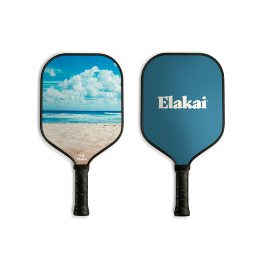 Two pickleball paddles with one featuring a beach scene and the other displaying the Elakai brand name.