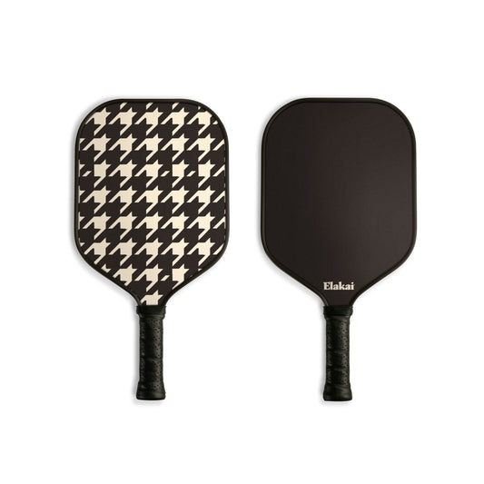Pickleball paddle with a houndstooth pattern and black on the other side. Elakai branding visible.