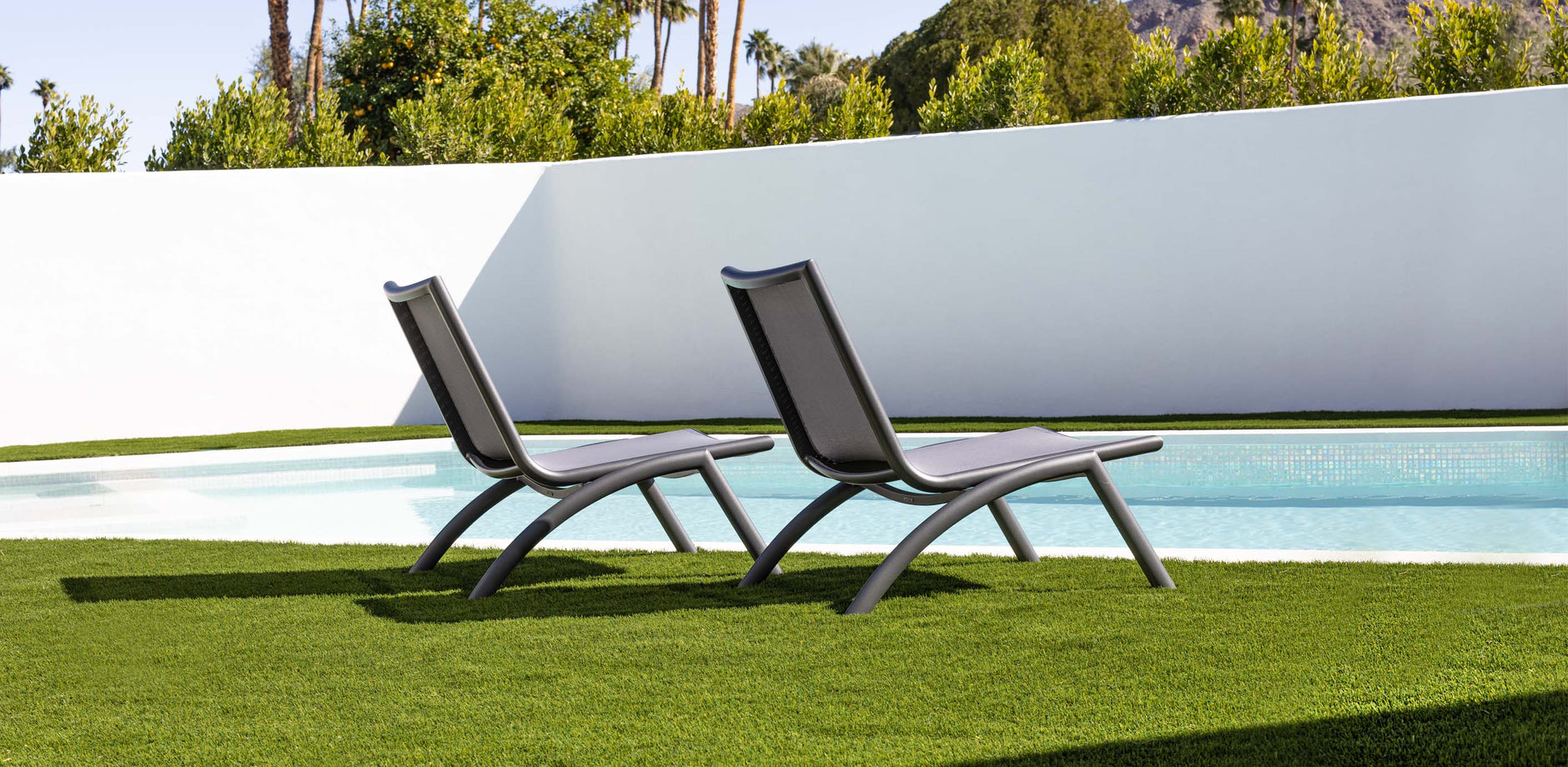 gray lounge chairs by the pool
