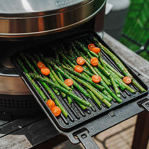 Grilled vegetables on a cast iron grill pan in a solo stove pizza oven.