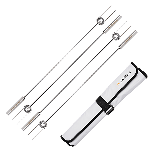 Set of four metal skewers with a carrying case on a transparent background