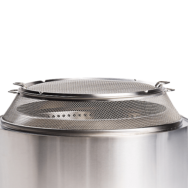 Stainless steel spark shield on top of a solo stove fire pit