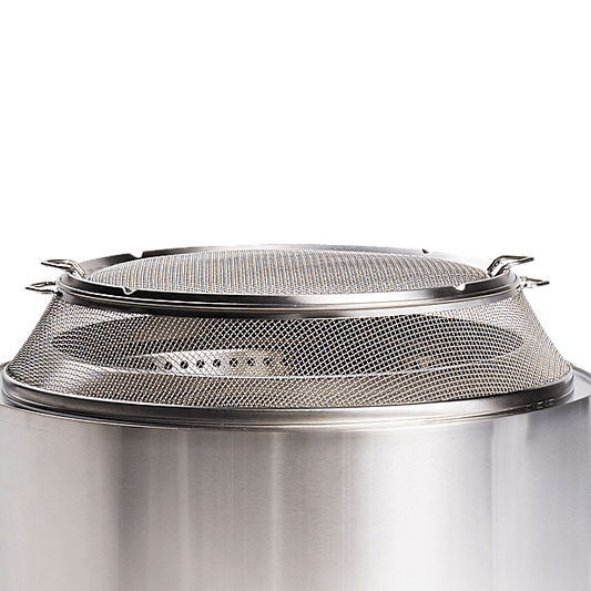 Stainless steel spark shield on top of a solo stove fire pit