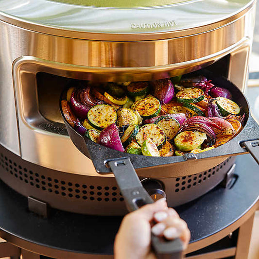 Solo Stove pizza oven with cast iron pan roasting veggies